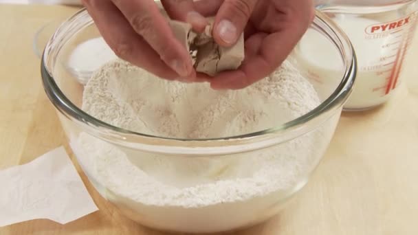 Yeast being crumbled and added to flour - Footage, Video