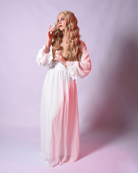 Full length portrait  of blonde woman  wearing white historical bridal gown fantasy costume dress.    Standing pose, facing forwards with gestural arms reaching out , isolated on studio background. - Φωτογραφία, εικόνα