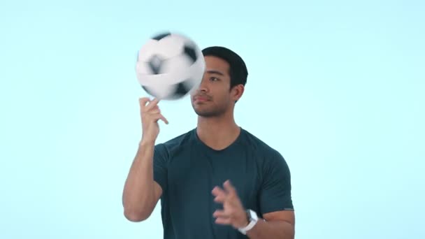 Soccer ball, smile and face of man in studio for sports trick, skill or practice with approval gesture. Happy, portrait and Indian male football player with ok hand sign isolated by blue background - Footage, Video