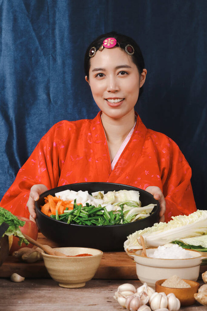 Krásná Korejka v krásném Hanboku dělá kimchi. Koncept korejského národního kostýmu. Fermentované potraviny - Fotografie, Obrázek