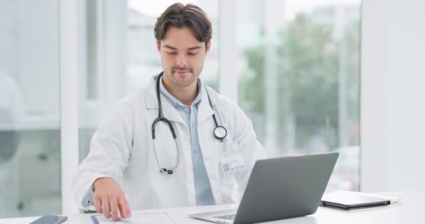 Doctor, laptop and writing on paper for results of patient, report or diagnosis in hospital office with smile. Professional, healthcare and information for research, paperwork or health planning. - Footage, Video