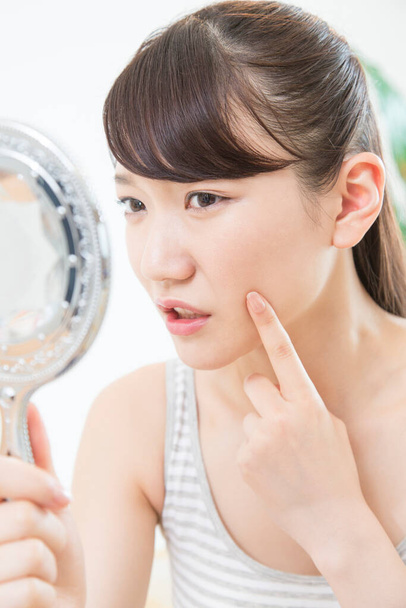 young  asian woman looking at mirror - Photo, image