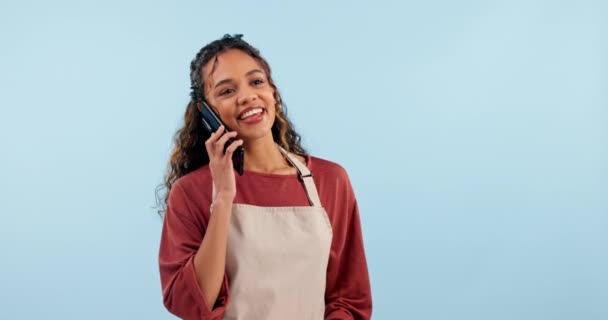 Barista, cafe worker and woman with phone call, chat with supplier and waitress in studio on blue background. Professional, communication and networking, small business and owner with inventory order. - Footage, Video