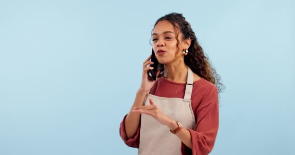 Small business, phone call and happy woman in studio with coffee shop, startup or conversation on blue background. Cafe, questions and lady boss with smartphone discussion for loan, planning or deal. - Footage, Video
