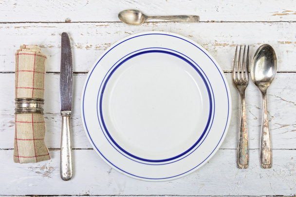 plate with silver cutlery on an old  table - Φωτογραφία, εικόνα