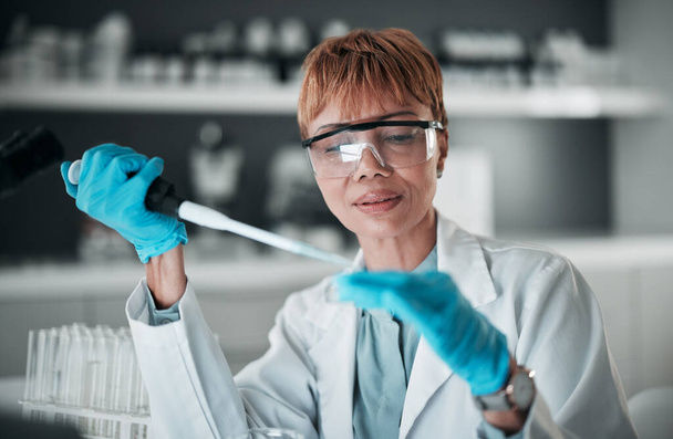 Scientist, black woman and pipette for dna blood engineering, medicine pharmacy or medical science research. Study, dropper or equipment in healthcare analytics test or future vaccine innovation. - Photo, Image