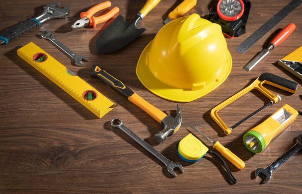Work tools with helmet on wooden background. - Photo, Image