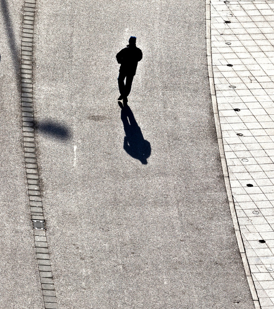Spaziergang auf der Straße mit langen Schatten - Foto, Bild