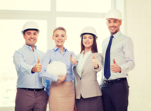 happy business team in office showing thumbs up - Фото, изображение