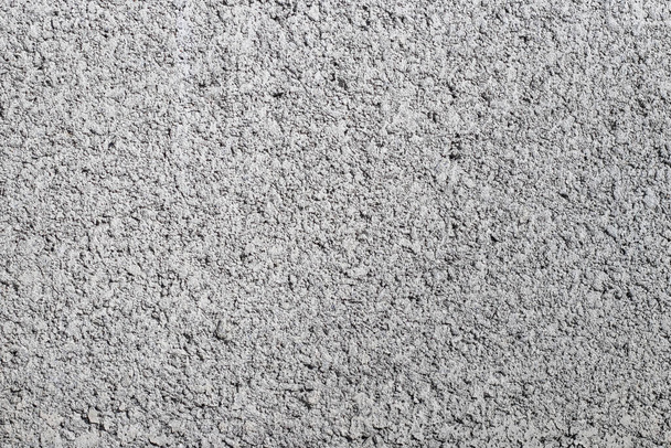 Αφηρημένο φόντο από την επιφάνεια ενός γκρίζου ακατέργαστου τσιμεντένιου τοίχου - Φωτογραφία, εικόνα