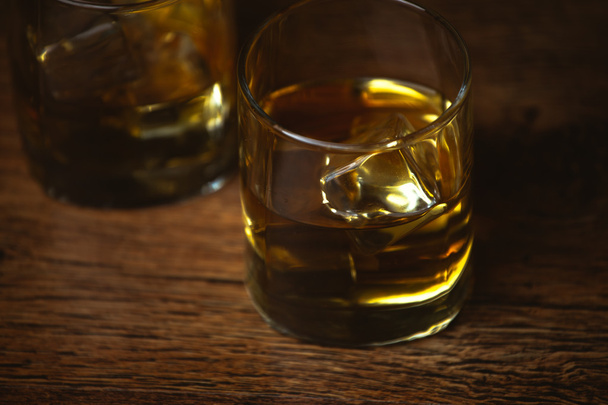 shot of whiskey on old wooden surface - Foto, imagen
