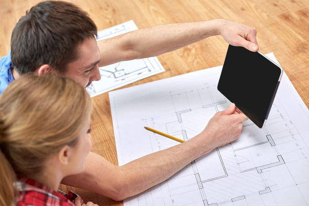 close up of couple with tablet pc and blueprints - Foto, Bild