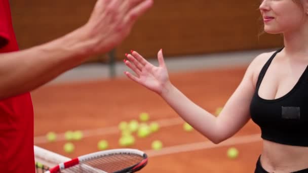 man and woman shaking hands before the start of a tennis game on open court sport players rivals close-up - Footage, Video