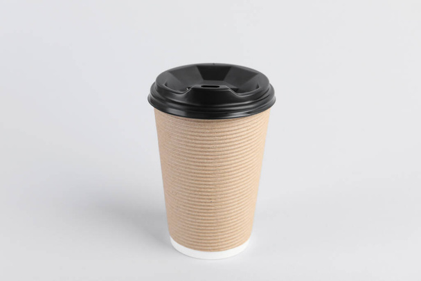 Paper cup with plastic lid on light background. Coffee to go - Fotó, kép