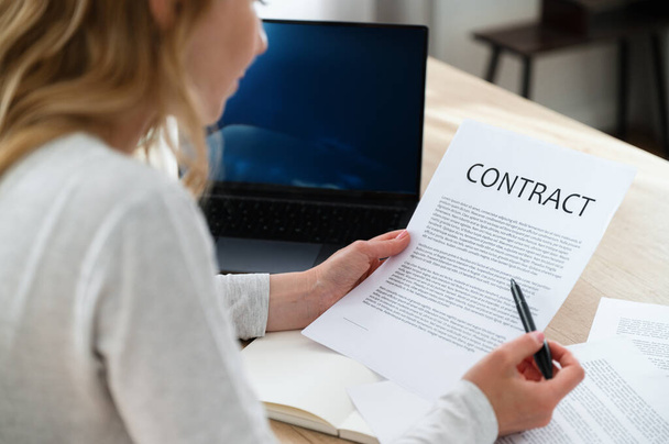 Manager thoughtfully reading contract for financing new project. Analyzing terms and conditions for marketing campaign. Notice important information in documents. - Photo, Image