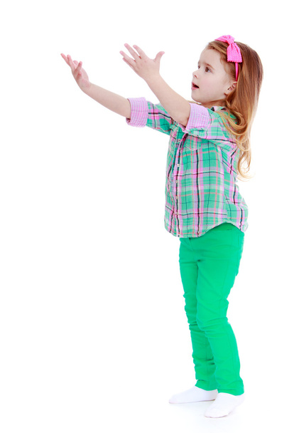 cheerful girl standing sideways outstretched hands - Fotoğraf, Görsel