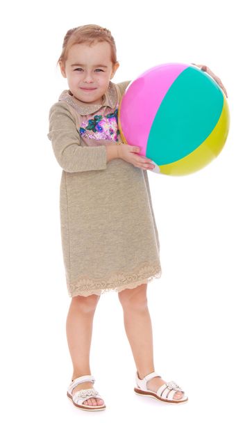 portrait of a little blond-wielding striped inflatable ball - Φωτογραφία, εικόνα