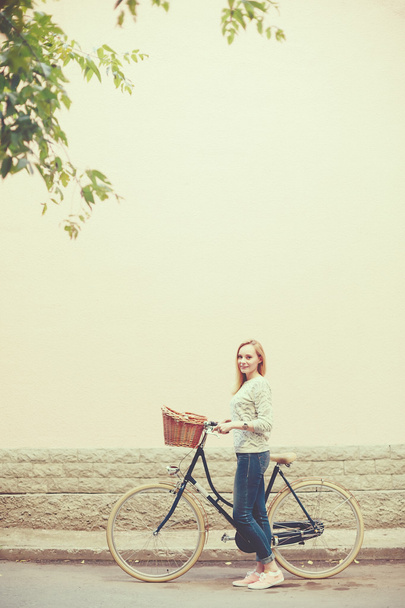 Young blonde woman on a vintage bicycle - Zdjęcie, obraz