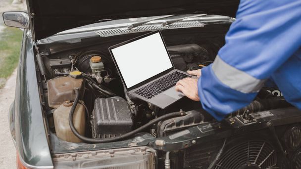 Car mechanic is inspecting the engine of a car coming in for repair at the center. Professional engine specialist, car repair, car breakdown. Car maintenance and repair concept. - Photo, Image