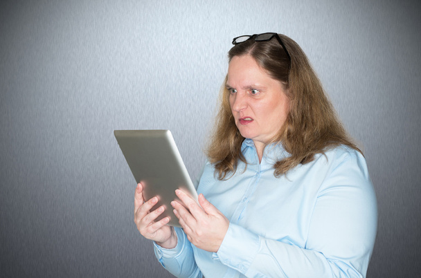 Woman is angry about a message she is reading - Photo, image