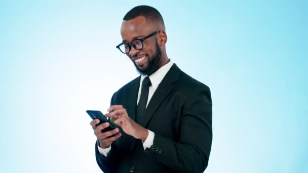 Happy businessman, phone and typing in social media, communication or networking against a studio background. Black man or business employee smile for online chatting or texting on mobile smartphone. - Footage, Video