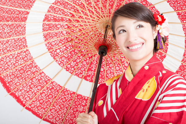 portrait of beautiful japanese woman in kimono with red umbrella  - Zdjęcie, obraz