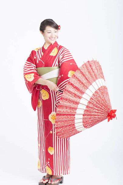 portrait of beautiful japanese woman in kimono with red umbrella  - Foto, immagini