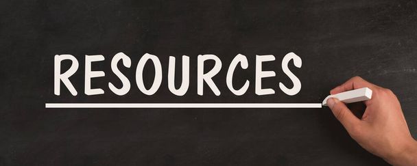 Resources is standing on a chalkboard, network, support of a team, environmental challenge, information and strategy concept - Photo, Image