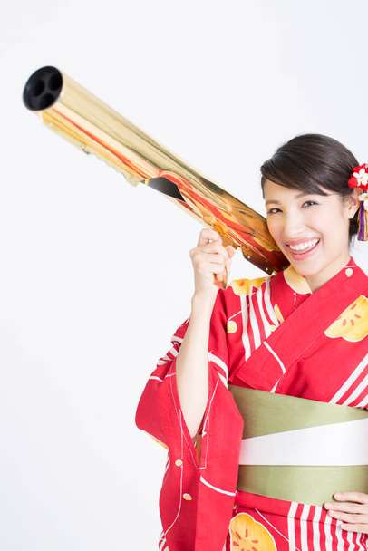 portrait of beautiful woman wearing japanese traditional costume holding telescope - Photo, image
