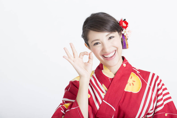 asian woman wearing traditional japanese dress showing ok sign - 写真・画像