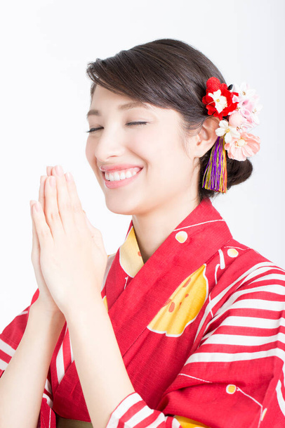 woman wearing traditional dress in japanese style  praying in the studio - Foto, Imagen