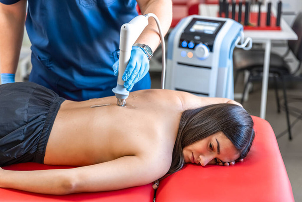 Extracorporeal shockwave therapy, physical therapy for neck and back muscles, spine with shock waves, pain relief, normalization and regeneration,stimulation healing process. - Photo, Image