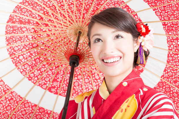 portrait of beautiful japanese woman in kimono with red umbrella  - Photo, Image