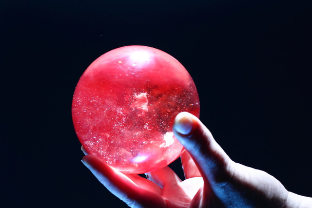 Female hand holding a Crystal Ball - Фото, изображение