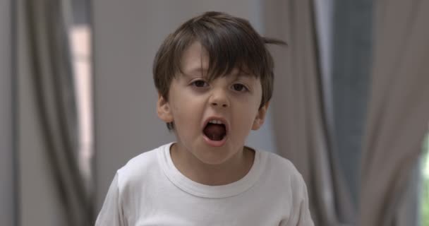 Upset child emotion in slow-motion. Close-up of angry little boy expressive face in 800 fps yelling and screaming at camera - Footage, Video
