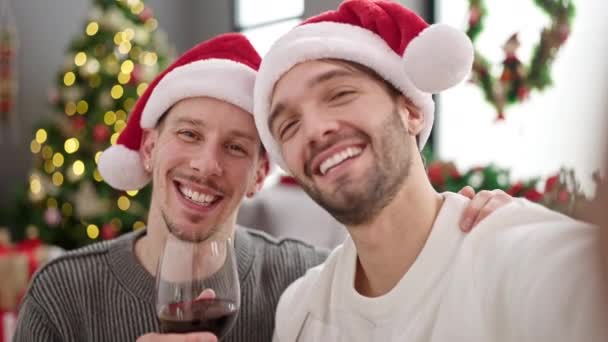 Two men couple celebrating christmas having video call at home - Footage, Video