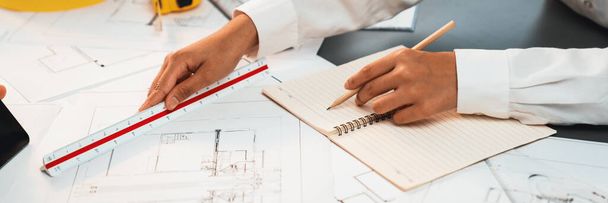 Architect or engineer working on building blueprint, contractor designing and drawing blueprint layout for building construction project. Civil engineer and architectural design concept. Insight - Photo, Image