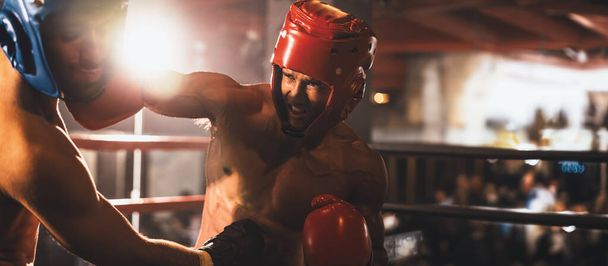 安全ヘルメットやボクシングヘッドガード付きの2つの運動および筋肉ボディボックスは激しいボクシングの試合で顔をオフにします。ボクシングリングで戦うボクシング戦闘機の競争相手。スプール - 写真・画像