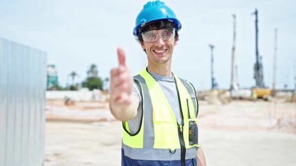 Young hispanic man architect smiling confident shake hand at construction place - Footage, Video