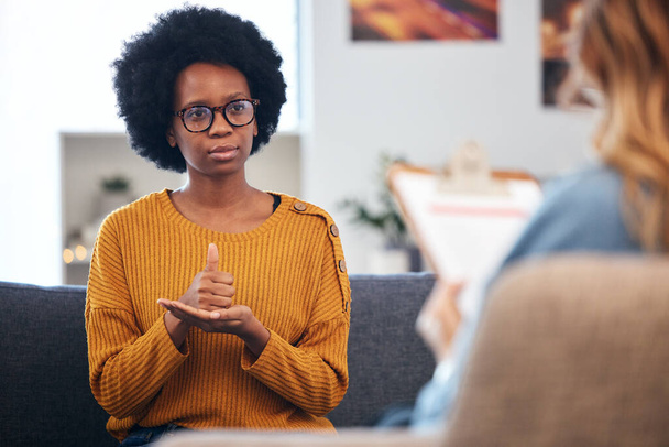 Lenguaje de señas, terapia del habla y mujer negra hablando con el terapeuta en una consulta o conversación de asesoramiento. Comunicación, apoyo y profesional Psicólogo ayuda persona con el aprendizaje. - Foto, imagen