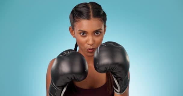 Boxen, Athlet und Gesicht des Boxkampftrainings mit Handschuhen isoliert in einem Studio blauen Hintergrund für die Übung. Fitness, Workout und Frauenporträt mit Energie für Gesundheit und Wohlbefinden in MMA. - Filmmaterial, Video