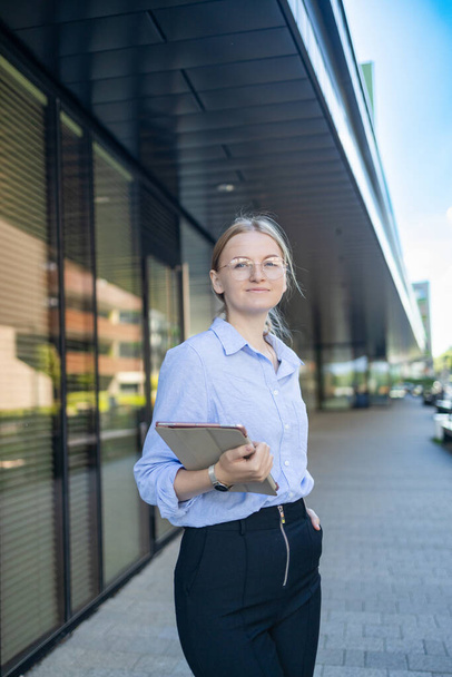 Young elegant professional leader Caucasian woman, female executive retail manager supervisor, small business owner wearing suit holding digital tablet standing outdoor looking at camera, portrait. - Фото, зображення
