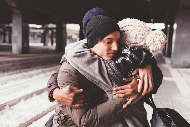couple standing in train station and embracing - Photo, Image
