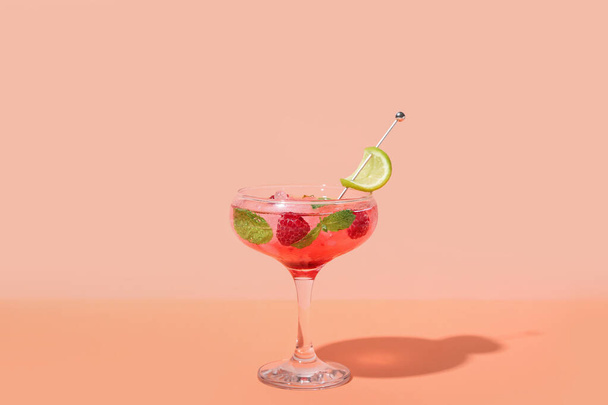 Glass of fresh raspberry mojito on colorful background - Photo, Image