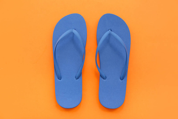 Paar blaue Flip-Flops auf orangefarbenem Hintergrund - Foto, Bild