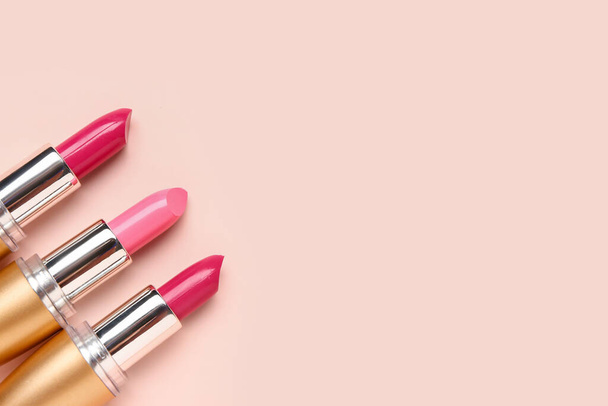 Different bright lipsticks on pink background - Photo, Image
