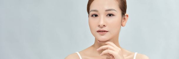 Woman with beautiful face touching healthy facial skin portrait on banner background - Photo, Image