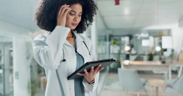 Tablet, doctor and hospital woman reading medicine study, cardiology report and check healthcare data, insight or statistics. Scroll, analysis and medical surgeon, nurse and clinic worker search web. - Footage, Video