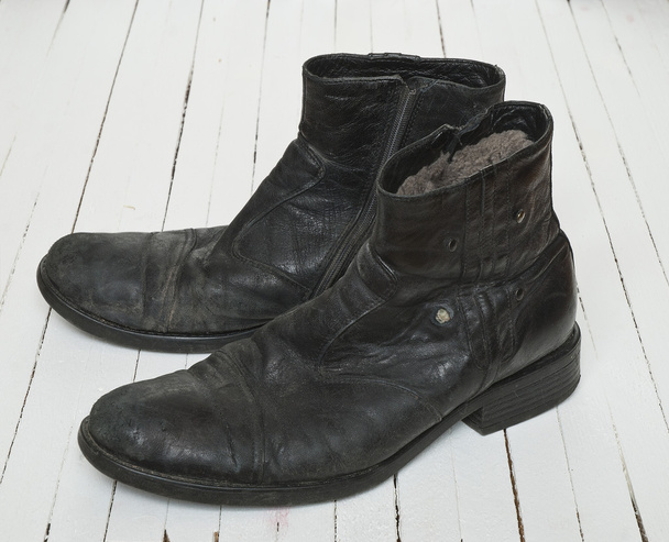 Old boot over white wood floor - Fotoğraf, Görsel
