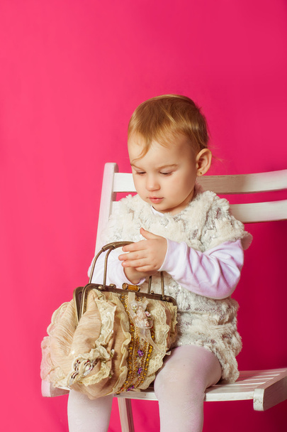 Little girl in a beautiful dress with a bag - Zdjęcie, obraz